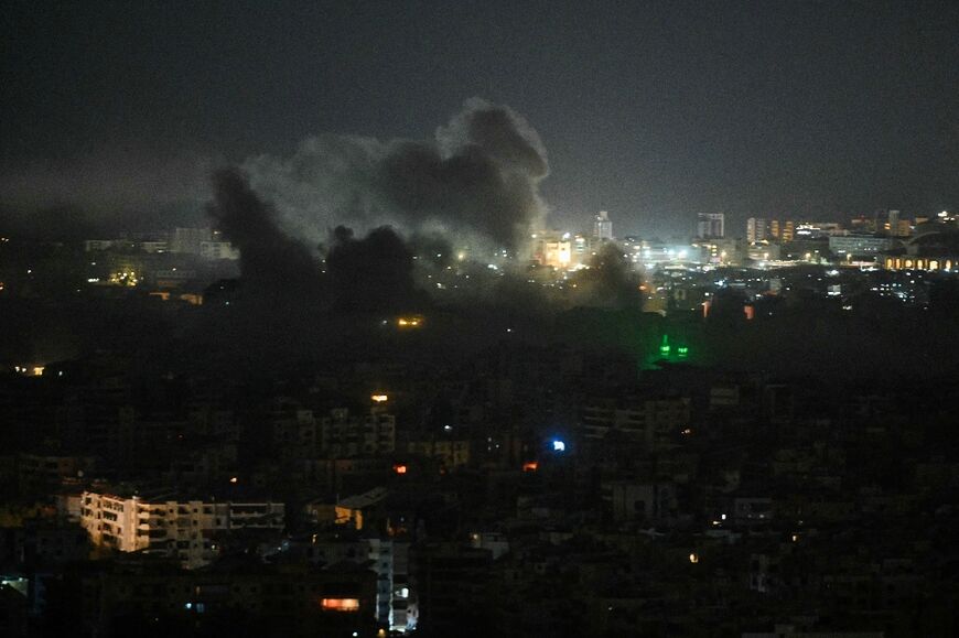 A plume of smoke rises from the site of an Israeli airstrike in the southern suburbs of Beirut early on March 12
