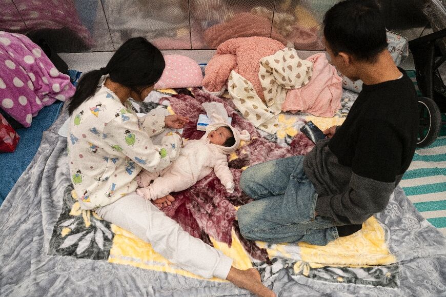 A family with a two-month-old child takes shelter in a train station in Tel Aviv during an ongoing rocket attacks from Iran in response to a US-Israeli attack