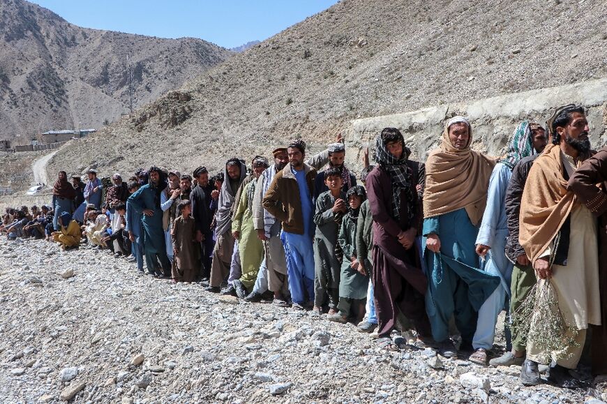 Afghan men queuing to receive fortified biscuits distributed by the World Food Programme