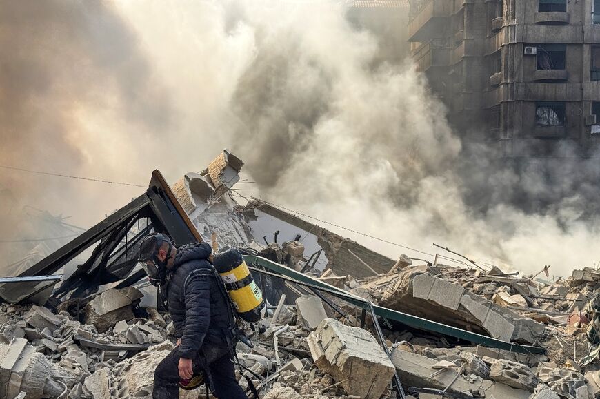 A firefighter inspects the debris after an Israeli air strike in southern Beirut