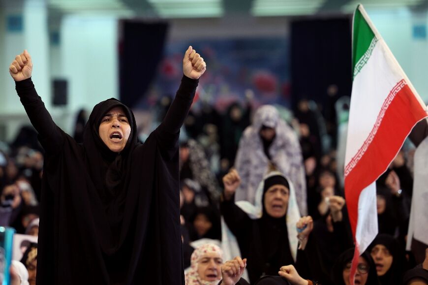 Iranian Shia women shout slogans during Eid al-Fitr prayers, marking the end of the Muslim holy month of Ramadan, despite the threat of intensified US and Israeli air strikes