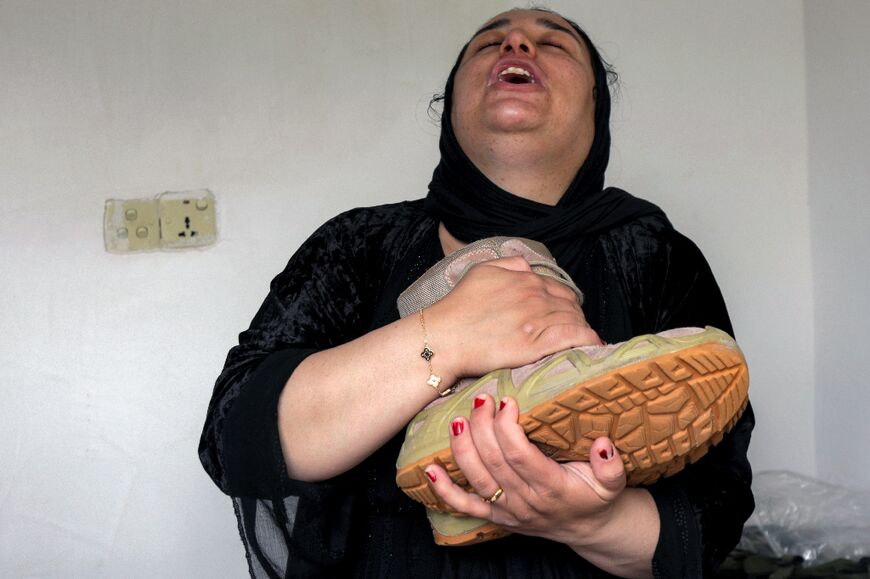 Fatima Muzafar, sister of an Iraqi Kurdish Peshmerga fighter killed in Iranian strikes on their military base, mourning him at his home in Soran, near the Iranian border