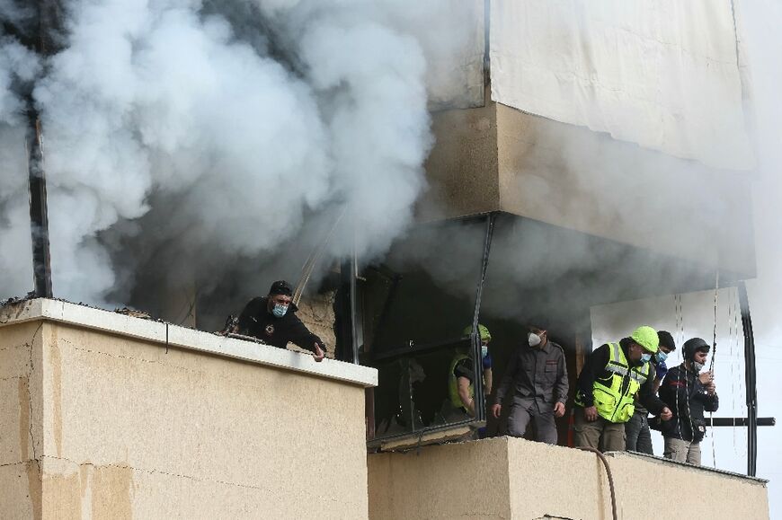 Emergency personnel work at the site of an Israeli airstrike that targeted an apartment in the southern Lebanese town of Haret Saida