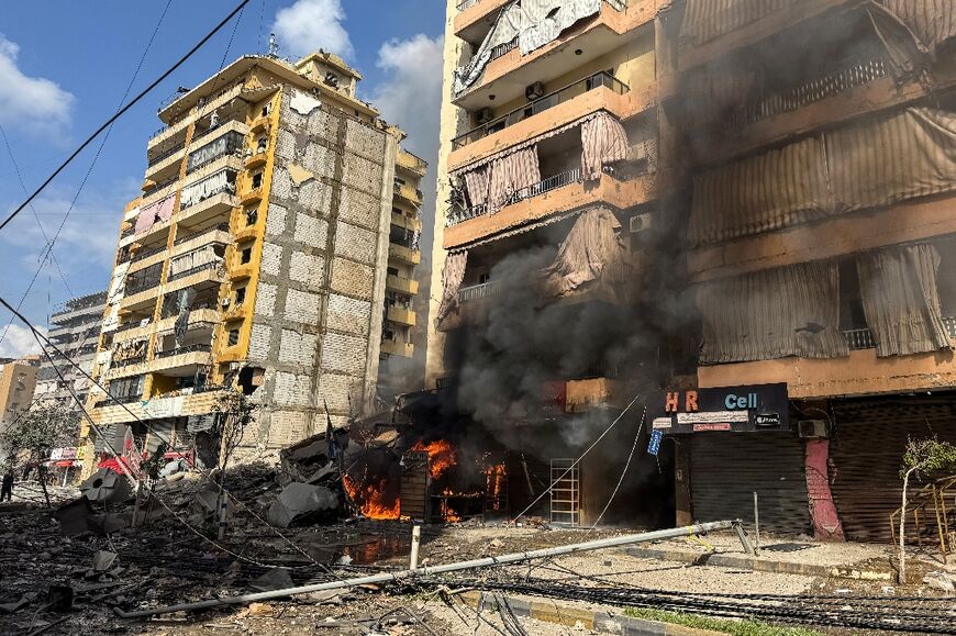 Flames and smoke rise from the site of an Israeli airstrike in Beirut's Haret district