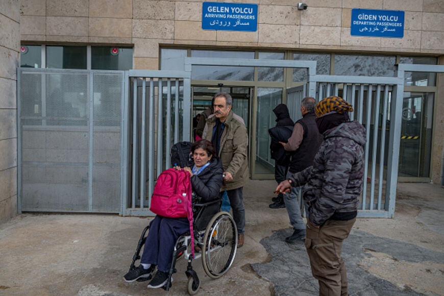 People, mostly Iranians who crossed from Iran at the Kapikoy border crossing, pull luggage in Turkey's eastern Van province on Friday, March 6, 2026, as the Iran-US-Israel conflict drove a rise in cross-border travel and displacement. (Photo by Murat Kocabas / Middle East Images / AFP via Getty Images)