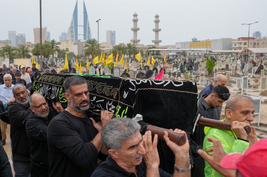 People carry the coffin of a person killed during a drone attack on a high-rise apartment building in Bahrain's capital Manama