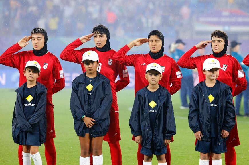Iran's players salute during the national anthem before the AFC Women's Asian Cup Australia 2026 football match between Iran and Philippines in Gold Coast on March 8, 2026