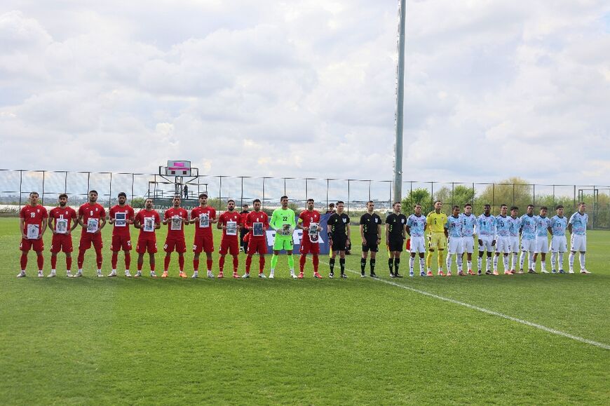 Iran's&nbsp;players wore black armbands and posed with photos of what officials said were young victims of the war, including those killed in an airstrike on a primary school in Iran on the first day of the conflict