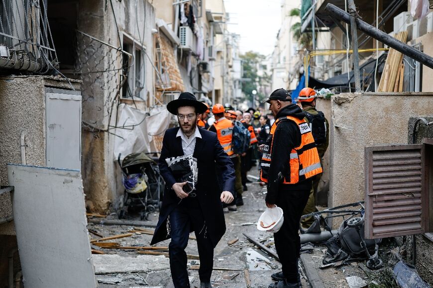 Residents and first responders at the scene following an Iranian strike in Bnei Brak in central Israel on Wednesday