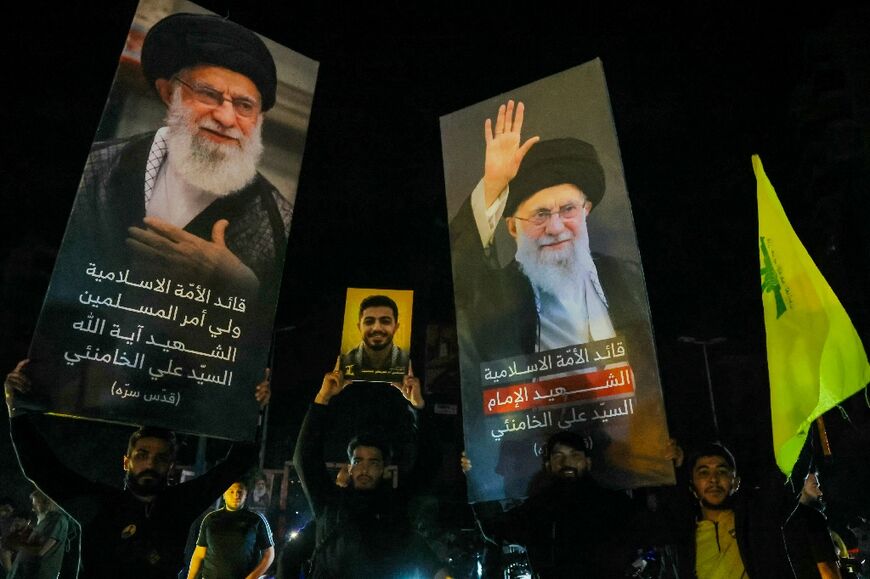 Supporters of Hezbollah in Beirut hold portraits of assassinated Iranian Supreme Leader Ayatollah Khamenei while celebrating the ceasefire with Israel as it takes effect
