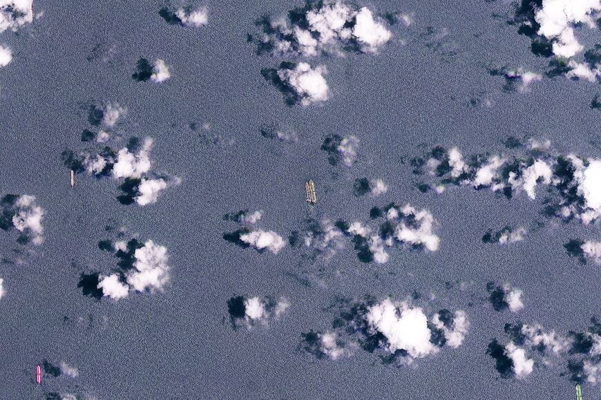 This handout satellite image released by Planet Labs PBC shows two vessels conducting what appears to be an offshore cargo transfer off the southeast coast of the Malay Peninsula near Singapore on March 24