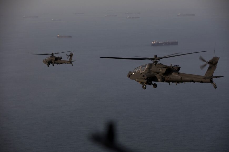 This handout photo released by US Central Command shows AH-64 Apaches flying above the Strait of Hormuz during a patrol on April 17, 2026