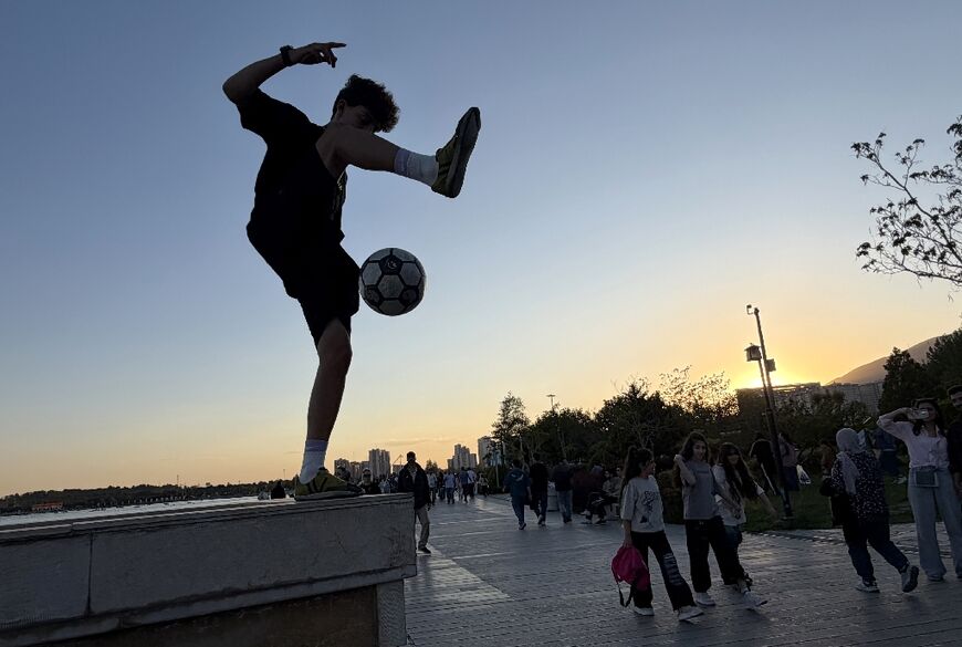 Tehranis coming out to enjoy the city's parks and cafes belies the mounting economic pressure that many are under