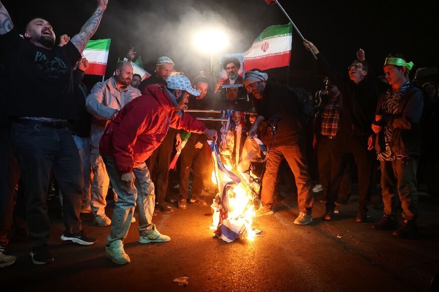 Iranians burn US and Israeli flags after the ceasefire announcement