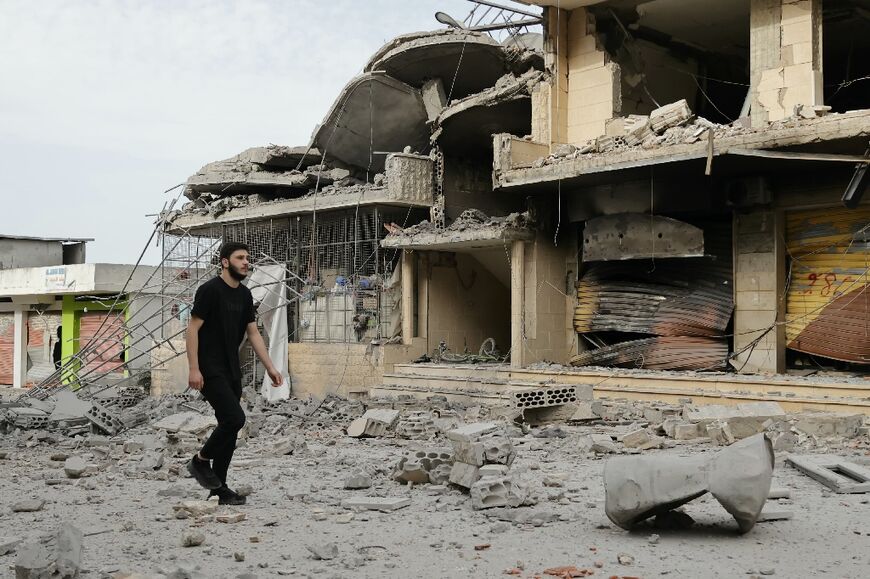 A resident observes destruction in a southern Lebanese border village that had been targeted by Israeli strikes 