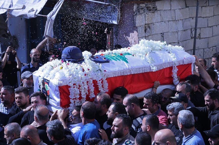 Mourners carry the coffin of Lebanese journalist Amal Khalil during her funeral procession in the southern town of  Bissariye