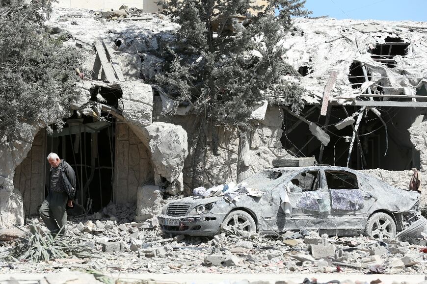 A man checks the site of an Israeli airstrike that targeted a religious Shiite complex the day before in the southern Lebanese coastal city of Sidon