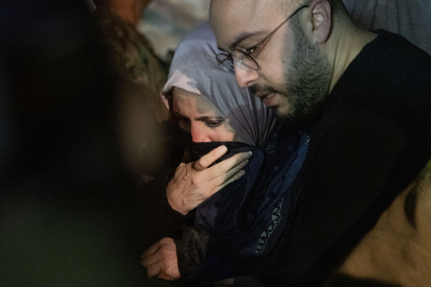 BEIRUT, LEBANON - APRIL 8: Rescue workers use a walk a woman to safety after she was rescued after she was trapped after an Israeli attack targeted a residential building on April 8, 2026 in Beirut, Lebanon. Israel has stepped-up its attacks on Lebanon following President Donald Trump's announcement of a two-week ceasefire agreement between the US and Iran. Israel says it will observe the ceasefire with Iran but insists Lebanon was not included in the deal, and has since launched the "largest coordinated st