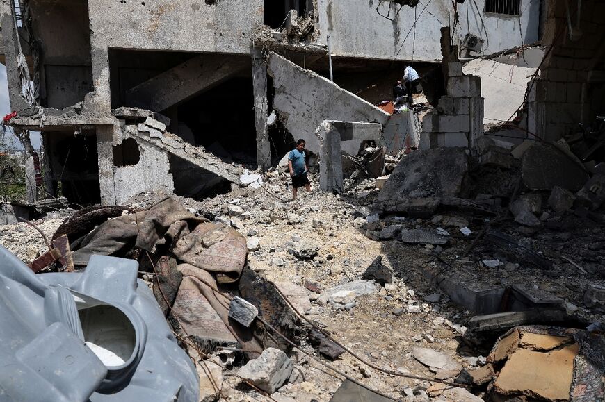 A young boy walks amid the rubble of a building destroyed in an Israeli strike in the southern Lebanese village of Kfar Sir on April 21, 2026