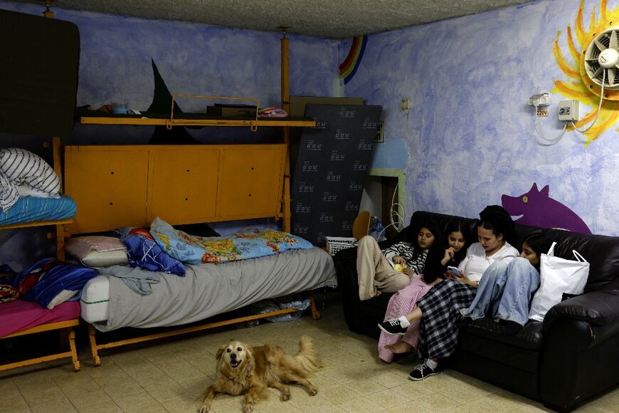 Kiryat Shmona resident Olga sits with her children in a shelter