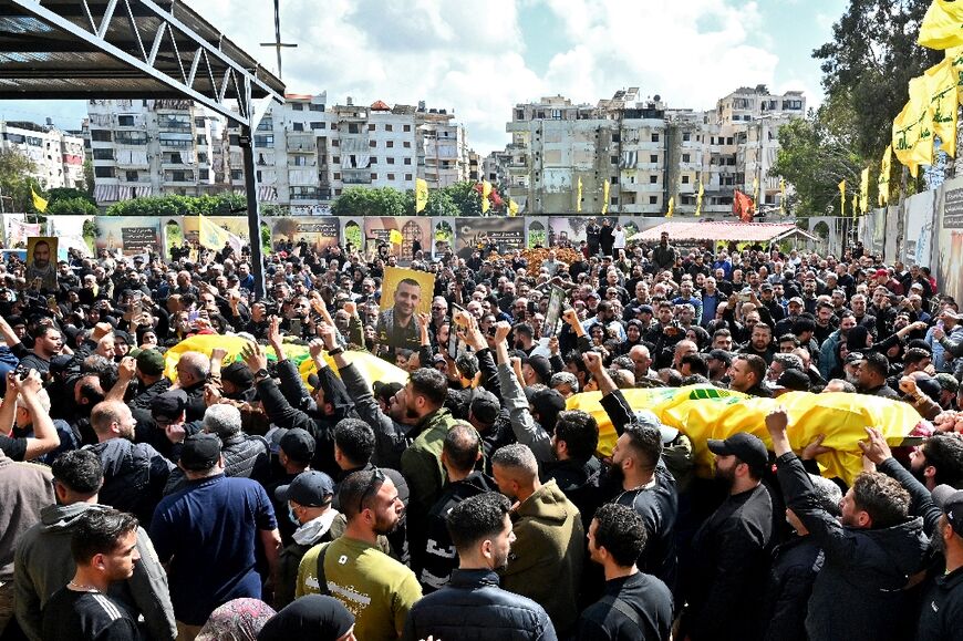 Mourners carry the flag-draped caskets of members of the Iran-backed militant group Hezbollah who were killed in southern Lebanon