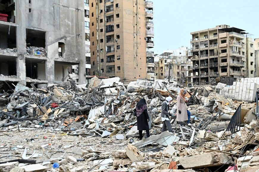 Women check on the destruction as they return to their neighbourhood in Beirut's southern suburbs