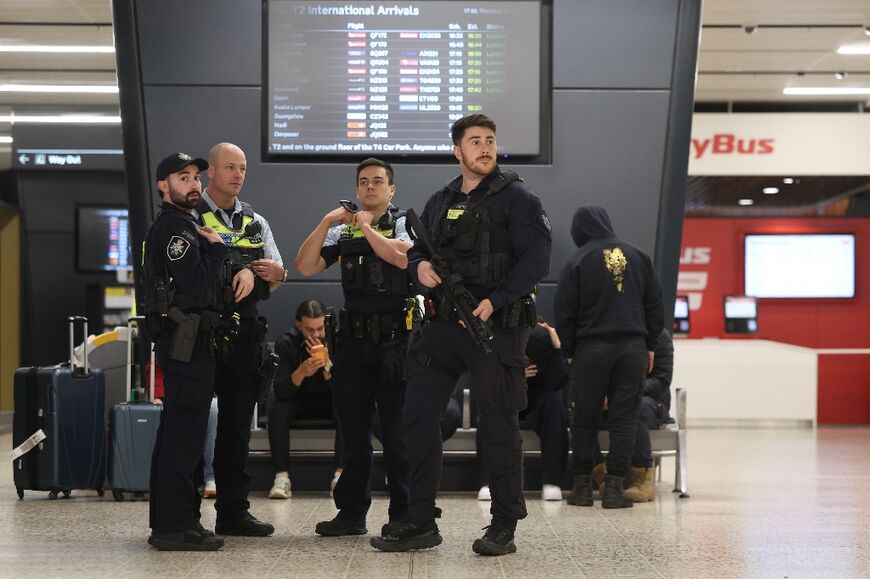 Police wait at Melbourne airport for the arrival of Australian women and children returning from Syrian camps