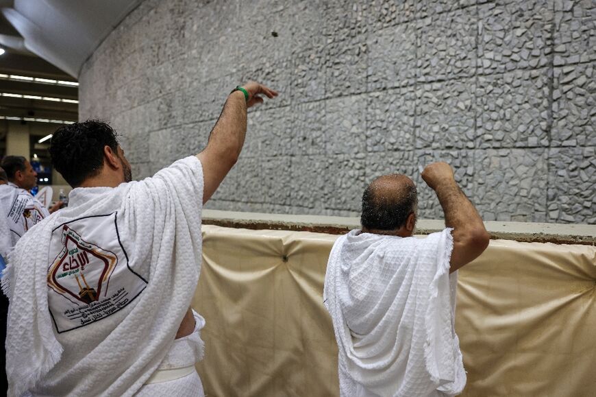 Pilgrims throw pebbles at giant concrete pillars during the final ritual of the hajj pilgrimage
