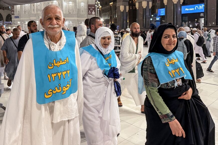Iranian pilgrims pose for a photograph at the Grand Mosque complex in the holy city of Mecca