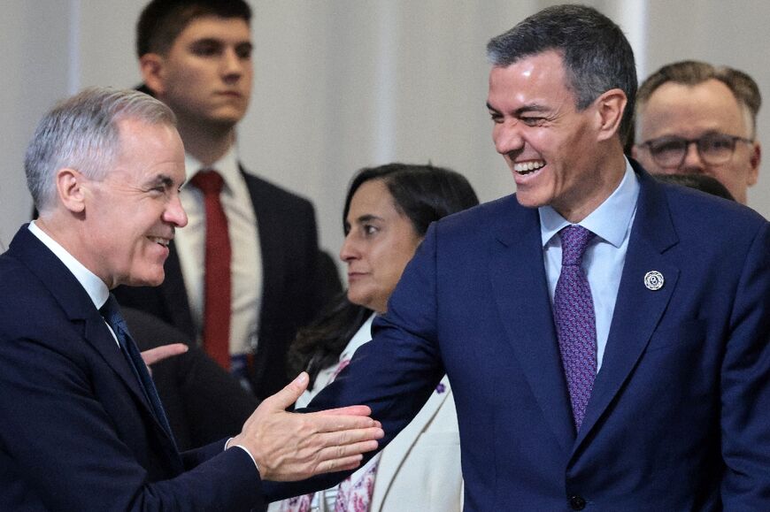 Canada's Prime Minister Mark Carney greets Spain's Prime Minister Pedro Sanchez at the European Political Community (EPC) summit in Yerevan