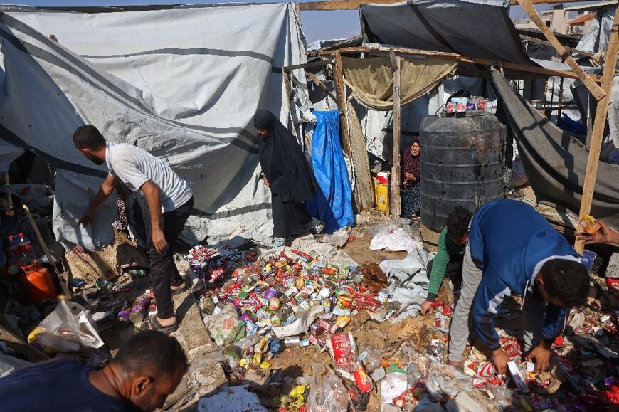 Displaced Palestinians scramble to preserve what's left after an Israeli strike targeted a food distribution tent in Khan Yunis