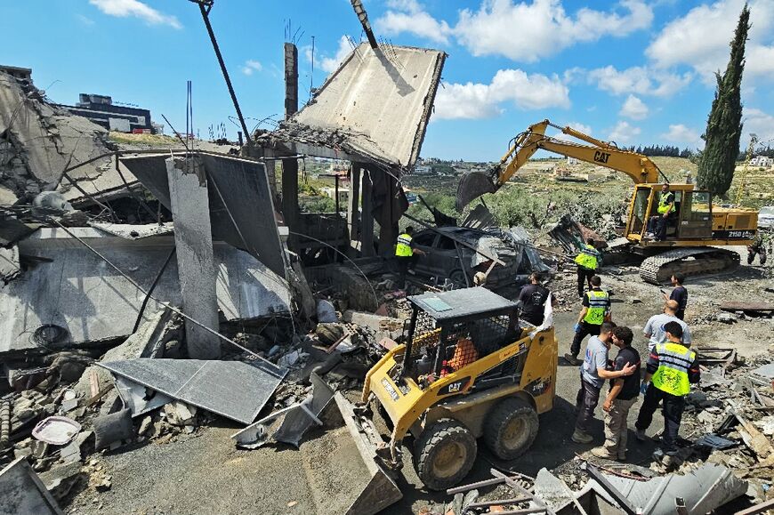 First responders search for survivors amongst the rubble at the site of an Israeli airstrike