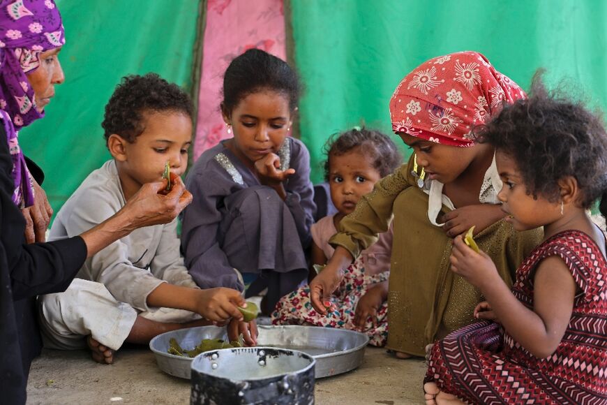 Saeedah Mohammed's family gathers to eat boiled tree leaves to stave off hunger