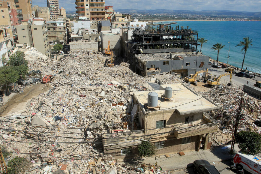 Diggers remove the rubble of buildings destroyed in Israeli strikes as they look for survivors buried underneath in the southern Lebanese coastal city of Tyre on April 21, 2026. Israeli defence minister said on April 21 that his country's campaign in Lebanon relied on both military and diplomatic pressure to disarm Iran-allied Hezbollah. Though a truce between Israel and Lebanon took effect on April 17, Israeli troops are still present and actively fighting Hezbollah militants in Lebanon's south. (Photo by 