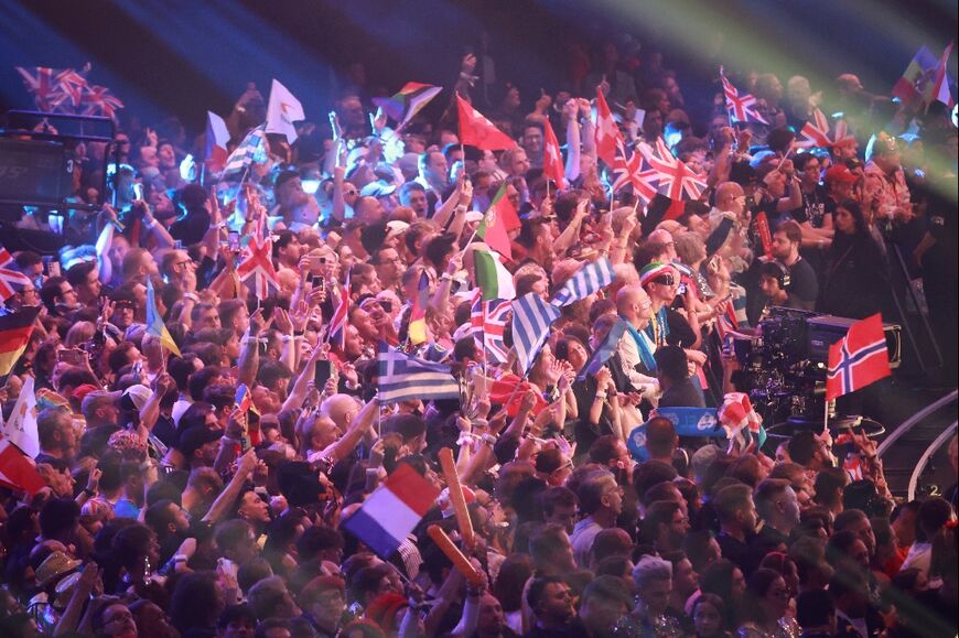 Fans wave flags during the final of the Eurovision Song Contest 2026 in Vienna
