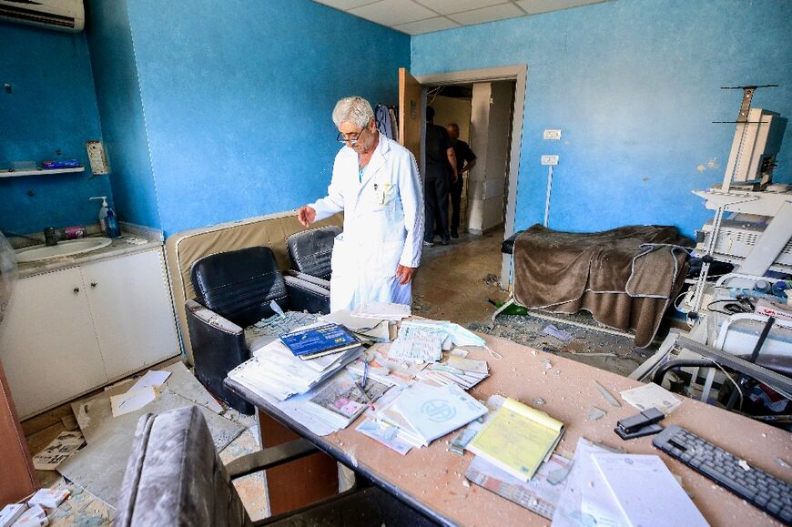 A doctor assesses the damage in his office