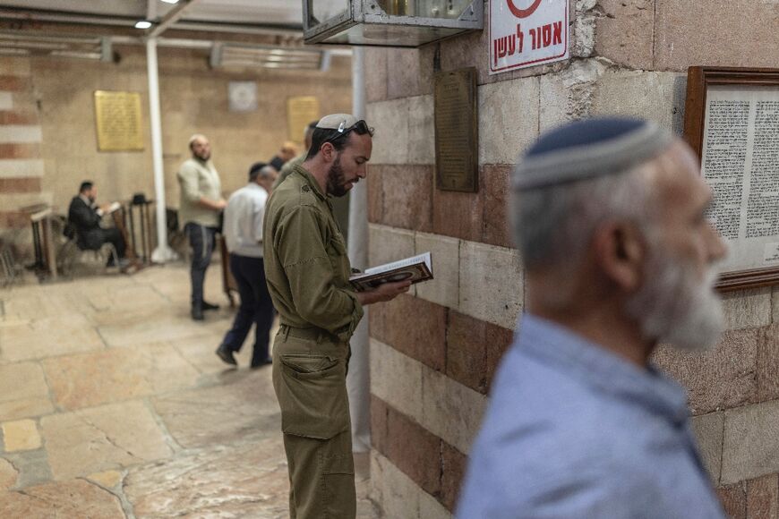 Jewish men pray at the Cave of the Patriarchs 