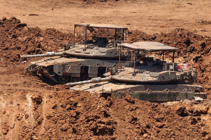 This picture taken from a position in the Upper Galilee in northern Israel shows Israeli tanks positioned along the border with southern Lebanon on June 22, 2026
