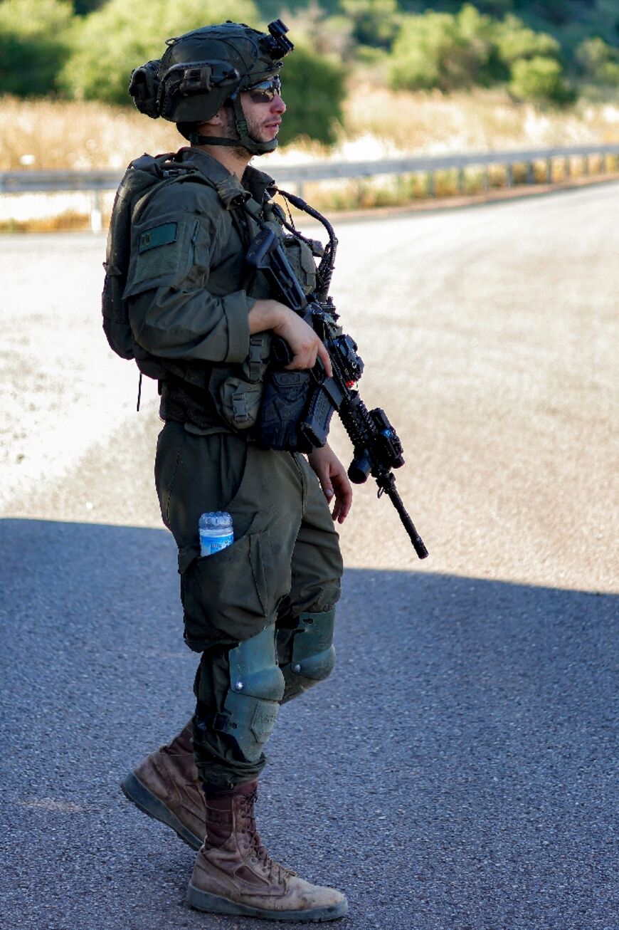 An Israeli army soldier patrols along the northern road near Moshav Margaliot in the Upper Galilee bordering Lebanon 