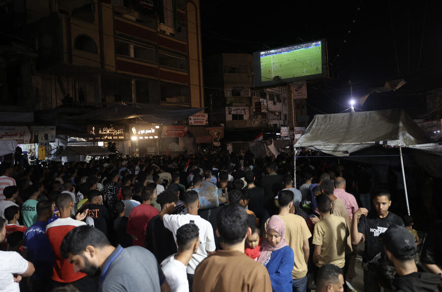 Palestinian football fans displaced from their homes which were destroyed by Israeli military strikes, watch the 2026 FIFA World Cup Group G match between Belgium and Egypt on a giant screen set up at the Nuseirat Refugee Camp in the central Gaza, on June 15, 2026. (Photo by Eyad Baba / AFP via Getty Images)