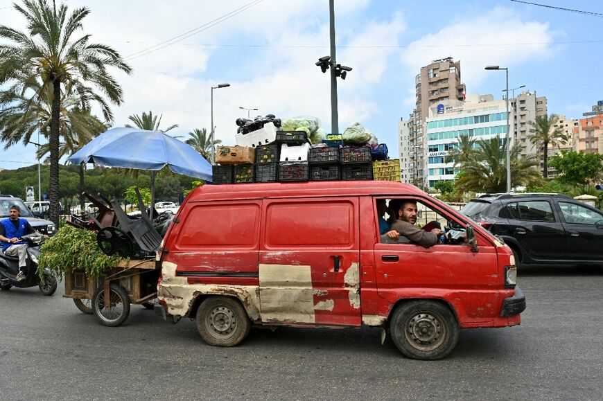 A street vendor flees with other residents after Israel ordered attacks on Beirut's southern suburbs