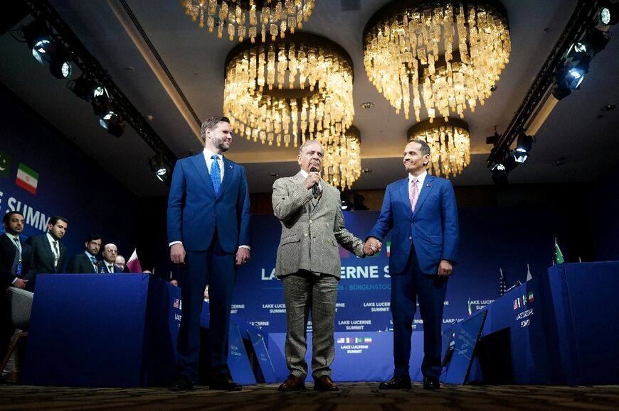 Pakistan's Prime Minister Shehbaz Sharif and his Qatari counterpart Sheikh Mohammed bin Abdulrahman bin Jassim al-Thani hold hands next to US Vice-President JD Vance prior to a quadrilateral meeting between the United States, Iran, Pakistan and Qatar