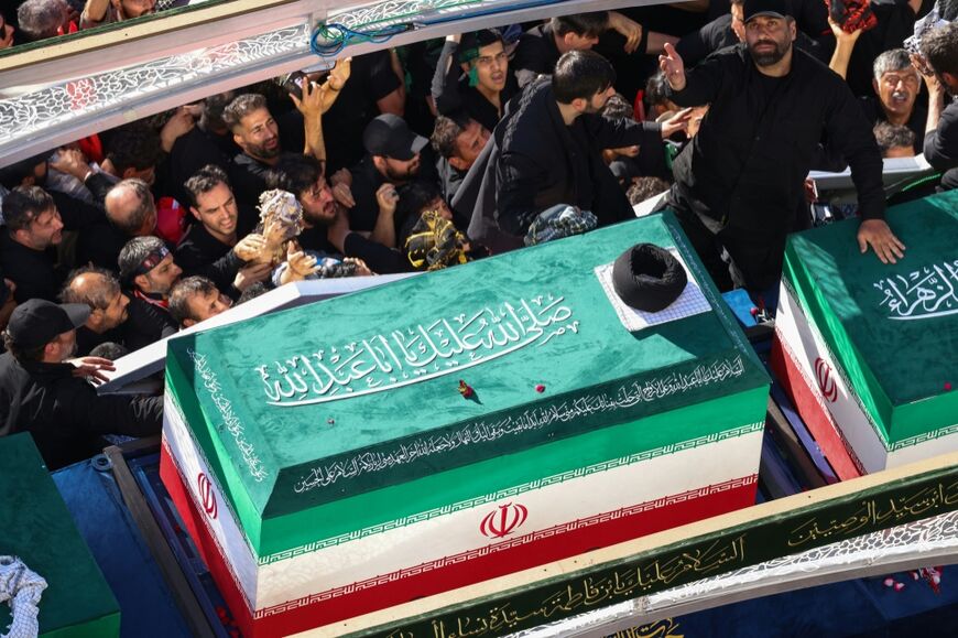 Mourners surround a convoy carrying the coffins of Iran's slain supreme leader Ali Khamenei and members of his family during a funeral procession, before he was buried in Mashhad at the shrine of Imam Reza, the country's most revered place of worship