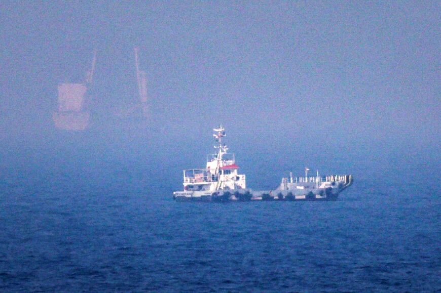Ships sail near the Strait of Hormuz off the eastern coast of the United Arab Emirates at Khor Fakkan on July 13, 2026