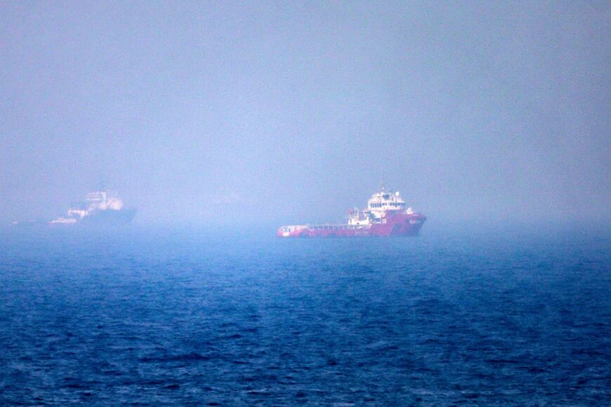 Ships sail near the Strait of Hormuz off the eastern coast of the United Arab Emirates on July 13, 2026
