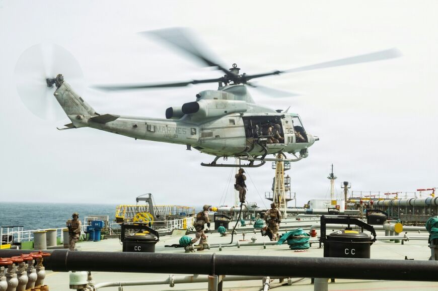 This US Marine Corps handout photograph taken on July 16, 2026, by US Central Command Public Affairs reportedly shows US Marines from the 11th Marine Expeditionary Unit conducting a verification boarding aboard M/T Wen Yao in the Gulf of Oman.