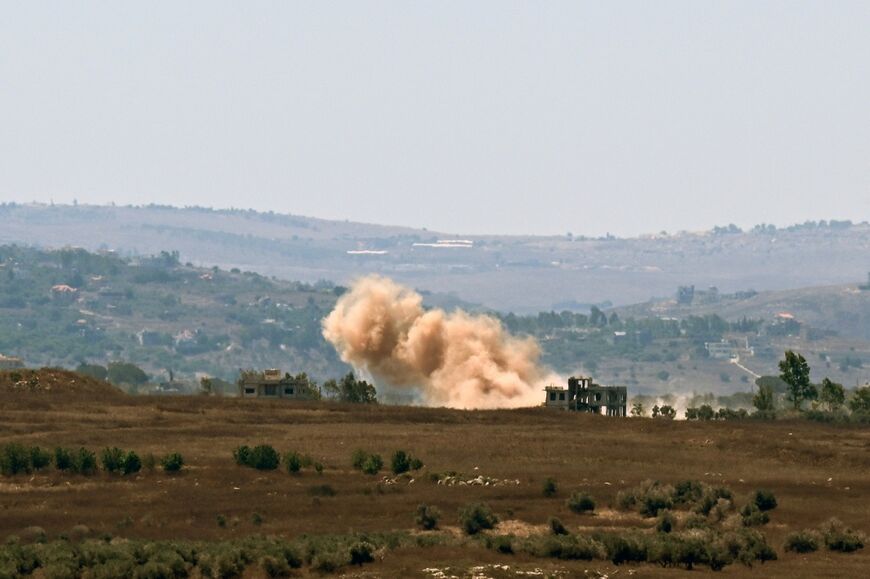 A photograph taken from Zawtar al-Gharbiyah shows smoke rising from the site of an Israeli-controlled explosion in the nearby village of al-Qantara