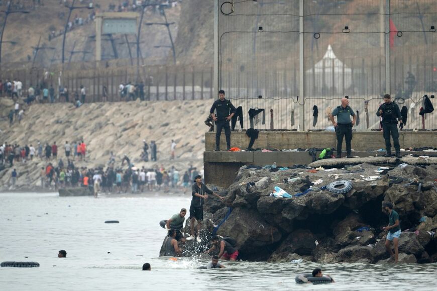 Many of the migrants have been swimming around a border barrier to get to Cueta