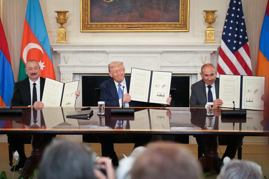 WASHINGTON, DC - AUGUST 08: U.S. President Donald Trump (C), Azerbaijani President Ilham Aliyev (L), and Armenian Prime Minister Nikol Pashinyan (R) hold up an agreement signed during a ceremony in the State Dining Room of the White House on August 8, 2025 in Washington, DC. The signed agreement is intended to bring an end to the conflict between Armenia and Azerbaijan that has lasted for decades. (Photo by Andrew Harnik/Getty Images)