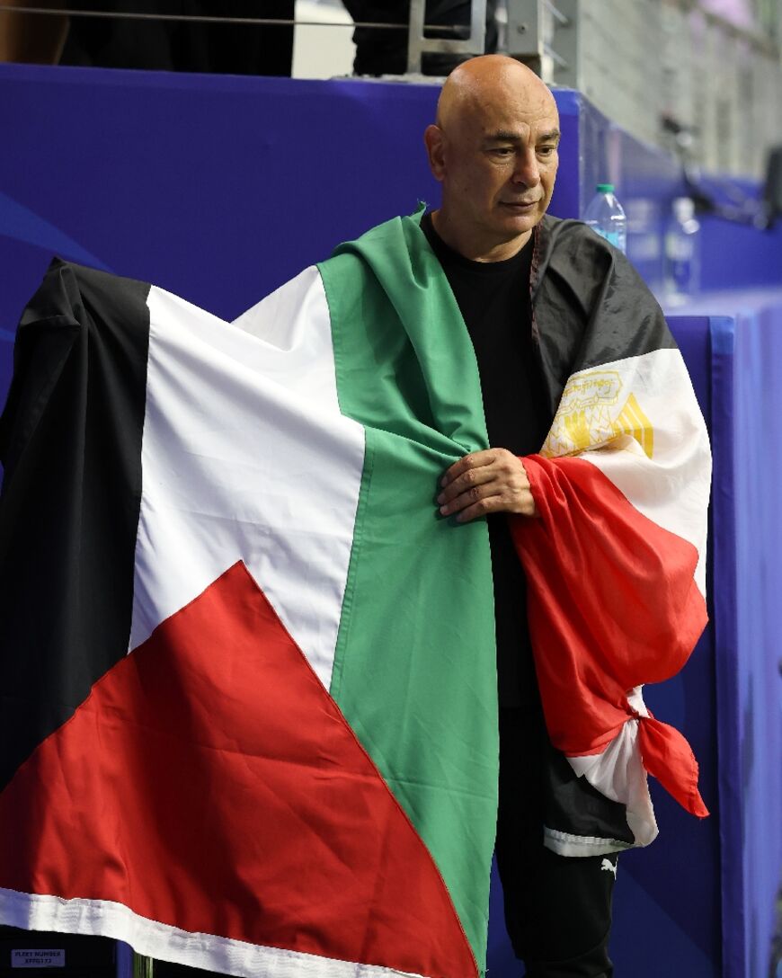 Egypt coach Hossam Hassan waved a Palestine flag after his side's World Cup win over Australia
